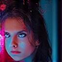 Portrait of a female lighting designer looking intently at a specialized lighting control panel.